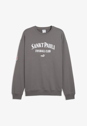 Felpa grigia con la scritta "SANKT PAULI FUSSBALL CLUB" in bianco. Polsini e orlo a coste, con una toppa con il logo sulla manica sinistra.