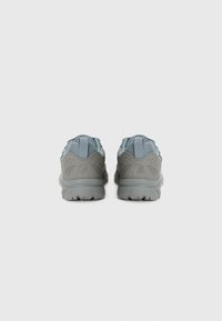 Gray athletic shoes with a textured surface, featuring a light blue mesh tongue and cushioned sole, designed for comfort and support.
