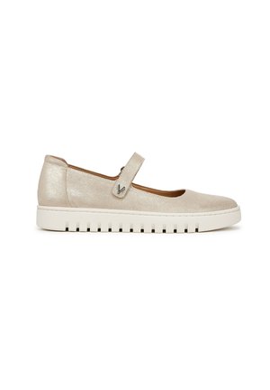 Beige metallic Mary Jane shoes with a round toe, Velcro strap, and white textured sole. Smooth upper material and minimalist design.