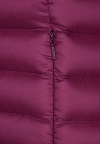 Purple puffer jacket with quilted sections and a full-length zipper. Smooth texture with subtle sheen. Zipper pull is matching purple.