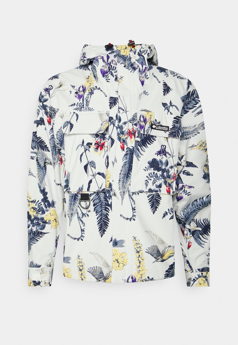 Veste blanche Columbia avec imprimé floral et fougères multicolores, deux poches avant à rabat, capuche ajustable et sangles aux poignets.