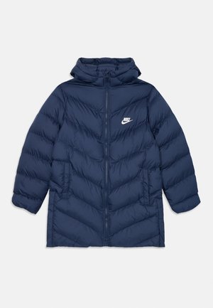 Navy blue puffer coat with a hood, zip closure, and chevron pattern. Features a white logo on the left chest and two side pockets.