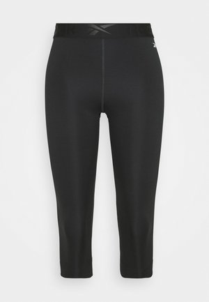 Leggings capri neri realizzati in tessuto elasticizzato con ampia vita elastica che presenta il logo Reebok. Texture liscia, design aderente.