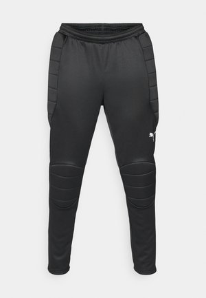Schwarze Sporthose mit gepolsterten Kniefeldern, taillierter Passform, elastischem Bund und Puma-Logo am linken Unterschenkel. Glatte Textur.