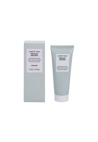 Nourishing hand cream in a light gray tube with white accents and a flip cap, next to a matching gray box with a label.