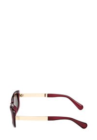 Auringonlaseissa on punertava sävy, ja niissä on kultainen metallinen siltarakenne ja varret. Varret ovat sileäpintaiset ja kapenevat kohti kärkiä. Tummat linssit.