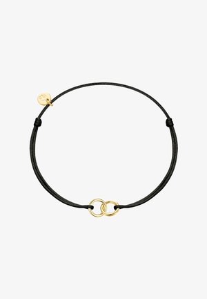 Bracelet en corde noire réglable avec deux petites bagues entrelacées en or et un petit pendentif en or.