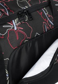 Black bag with colorful floral pattern, featuring a double zipper closure and a smooth inner compartment. Textured fabric with robust stitching.