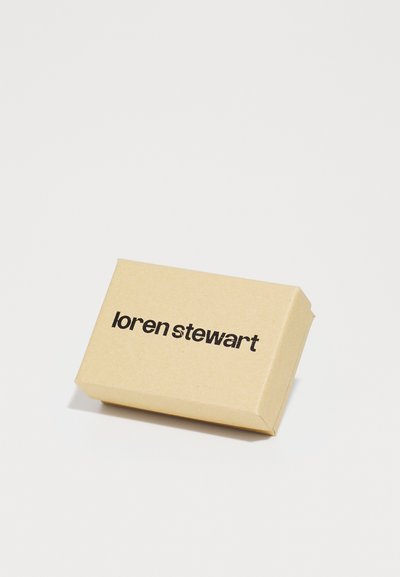 Boîte en papier kraft de forme rectangulaire, avec le texte imprimé en noir "loren stewart" sur le devant. Texture lisse, design minimaliste.