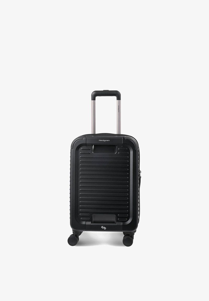 Valise cabine rigide noire avec poignée extensible et quatre roues, conçue pour une parfaite maniabilité et un confort de voyage.