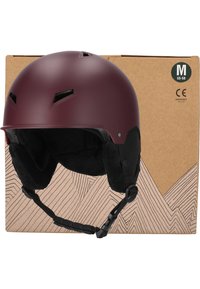 Casque de ski marron avec des trous de ventilation, oreillettes noires douces, mentonnière réglable et taille marquée M (55-58) sur l'emballage en carton.
