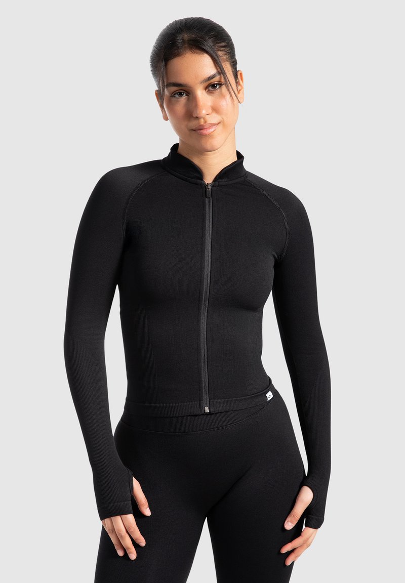 Black athletic zip-up jacket with long sleeves, high collar, and thumbholes. Soft, stretchy fabric and fitted design for comfort.