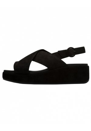 Black suede wedge sandals featuring cross strap design, open toe, adjustable ankle strap with round buckle, and thick platform sole.
