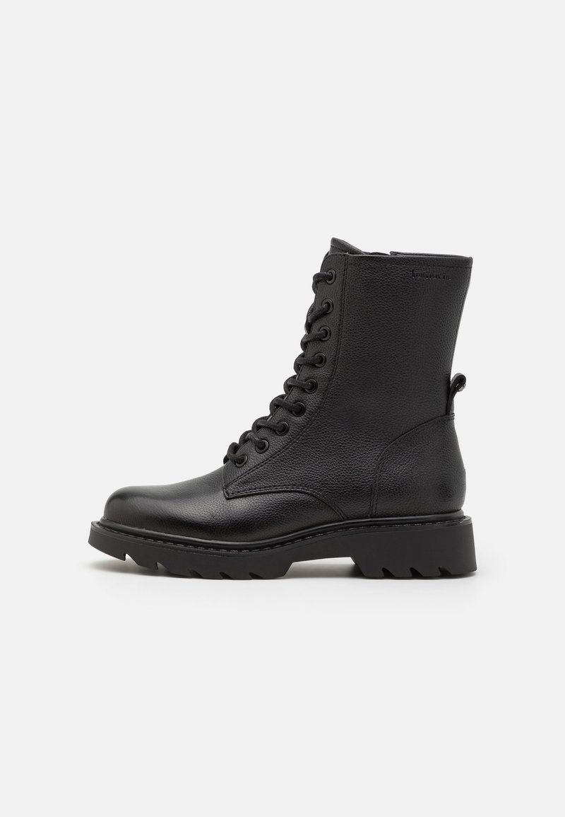 Black leather lace-up boots with a textured finish, round toe, and chunky rubber sole featuring pronounced treads for better traction.