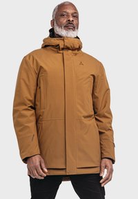 Braune, wasserdichte Jacke mit hohem Kragen und verstellbarem Kapuze. Sie hat eine glatte Textur, Fronttaschen und ein Logodetail auf der Brust.