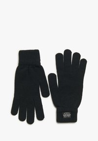 Guantes de lana negros con puños acanalados, con una etiqueta que dice "Ropa de Trabajo Tradicional Superdry". Textura suave y diseño ajustado.