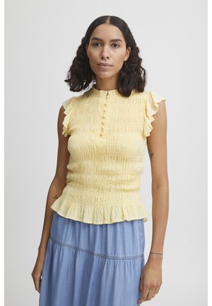 Yellow smocked top with a round neckline, short ruffled sleeves, and a peplum hem. Features decorative buttons down the front and textured fabric.