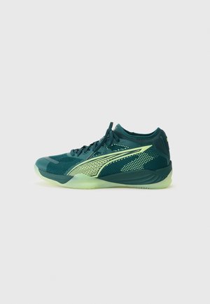 Chaussure de sport avec une tige en mesh vert foncé et des accents vert clair, un talon moulable et une semelle texturée pour une meilleure adhérence.