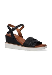 Zwarte leren wedge sandalen met een gekruist bandontwerp, open teen, verstelbare enkelband en een witte rubberen zool. Geweven bovenkant en houten inlegzool.