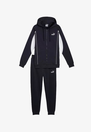 Tuta Puma nera con giacca con cappuccio con zip e pannelli laterali bianchi e pantaloni jogger abbinati, entrambi con logo Puma.