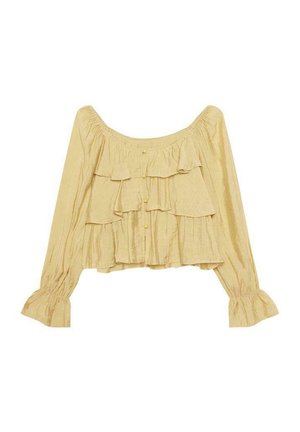 Blusa amarilla de capas con mangas largas y acentos de volantes. Presenta un escote amplio y un cierre de botones al frente con una textura sutil.