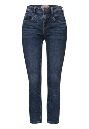 Tummansiniset skinny-farkut, joissa on tuplapainonapitus, etu- ja kolikkotaskut, näkyvät saumat ja kevyttä haalistumista.