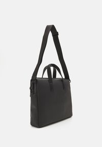 Borsa in pelle nera con superficie testurizzata, doppie maniglie e tracolla regolabile. Forma rettangolare con un design minimalista e senza embellishments visibili.