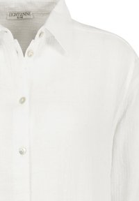 Weißes Hemd mit Knopfleiste aus strukturiertem Stoff. Verfügt über einen Kragen, fünf Knöpfe und eine lockere Passform. Markenetikett: EIGHT2NINE, Größe S/M.