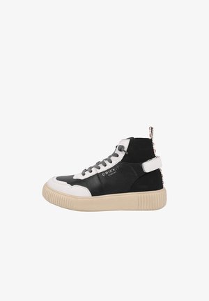 High-top sneakers with black leather and white accents, textured suede, rubber sole, branding on the side, and a patterned heel loop.
