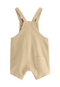 Beige katoenen overall met verstelbare bandjes, een rechthoekige zak aan de rechterkant en een eenvoudig, functioneel ontwerp.