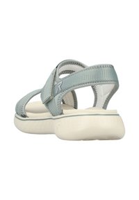 Light blue adjustable sandal with textured straps, cushioned white sole, and a secure back strap. Features a logo on the side and open design.