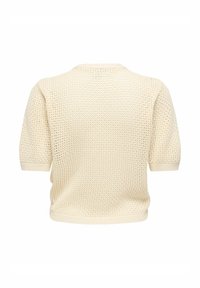 Pull tricoté couleur crème à manches courtes, présentant un motif en nid d'abeille texturé et un col rond. Fini avec des bords côtelés.