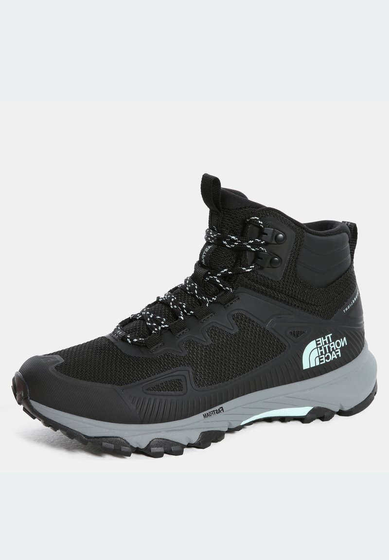 Bottes de randonnée noires avec empeigne en mesh, accents réfléchissants, semelle grise amortissante et lacets à motif, adaptées aux terrains accidentés.