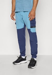 Under Armour UTILITY PANT - Tracksuit bottoms - washed navy/blue smoke/black