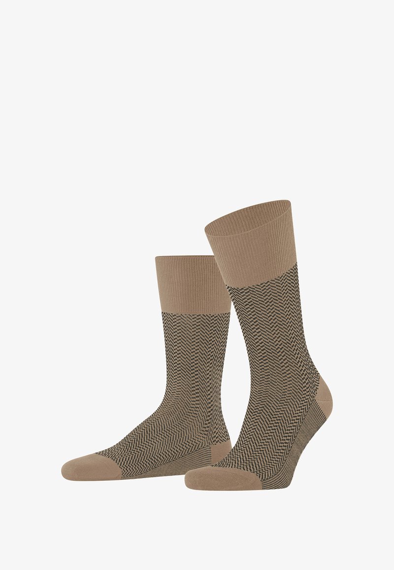 Braune Socken mit Fischgrätmuster, gerippten Bändern oben und einfarbigen braunen Zehen. Weicher Stoff mit mittlerer Höhe.