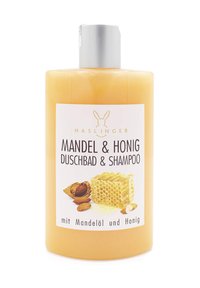 Flasche mit Mandel- und Honig-Duschgel und Shampoo; durchsichtige gelbe Flüssigkeit, silberner Deckel, weißes Etikett mit schwarzem Text und Produktbild.