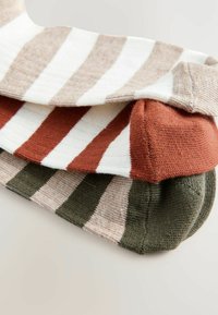 Striped socks in three colors: white with beige, maroon, and olive green. Soft, ribbed texture with varied stripe widths and color blocking.