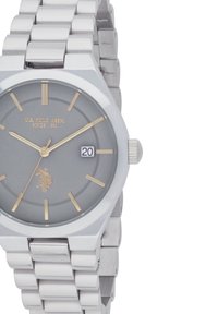 Montre pour homme en acier inoxydable argenté avec un cadran gris, des index dorés et un affichage de la date. Caractéristiques d'une finition polie et d'un bracelet maillé.