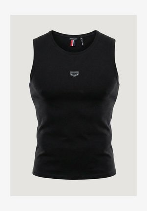 Débardeur noir en coton sans manches avec un col rond, présentant un petit patch logo gris sur la poitrine et une texture lisse.