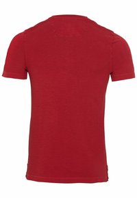 T-shirt rosso a maniche corte con scollo rotondo, texture liscia e orli cuciti. Nessun logo o motivo visibile sul retro.
