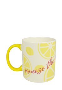 White ceramic mug with yellow handle, featuring lemon slice patterns and the phrase "squeeze the day" in pink cursive lettering.