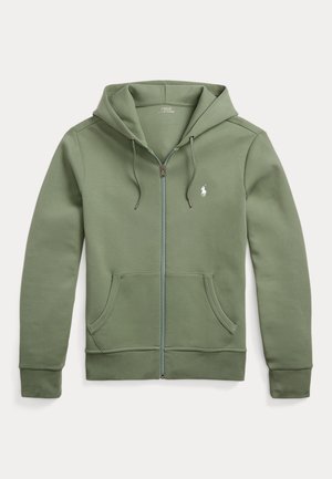 Haut à capuche zippé vert en tissu doux, avec une fermeture éclair à l'avant, deux poches latérales et un petit logo sur la poitrine gauche.