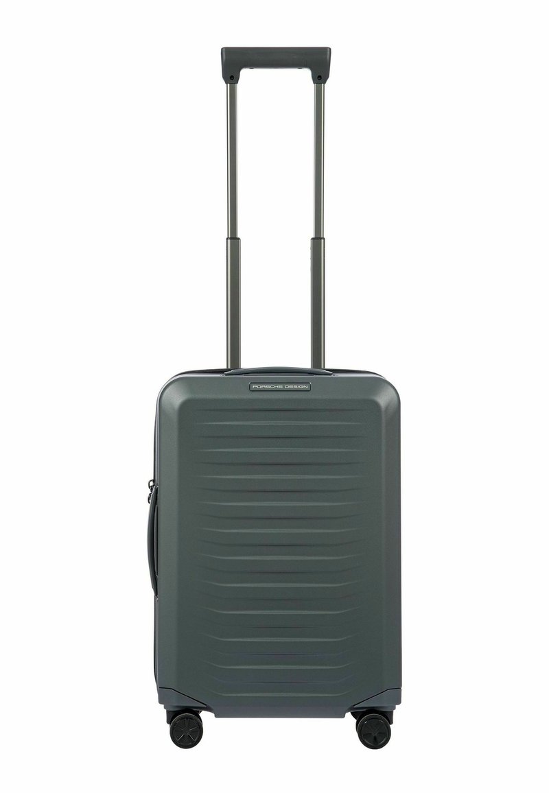 Valigia rigida di colore grigio scuro con superficie testurizzata, manico estensibile e quattro ruote nere per la mobilità. Logo del marchio sulla parte anteriore.