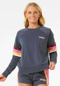 Marineblauwe sweatshirt met multicolore strepen (bruin, roze, geel, wit) op de mouwen. Geribbelde boorden en zoom, logo op de borst. Zacht, casual materiaal.