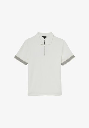 Valkoinen lyhythihainen poolopaita, jossa on vetoketju edessä, kaulus ja mustavalkoraidalliset hihansuut.