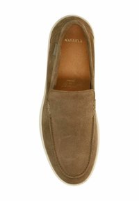 Brown suede slip-on shoe with a rounded toe, white rubber sole, and subtle stitching detail on the upper and side. Interior leather lining.