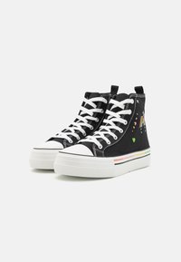 Černé vysoké tenisky s bílými tkaničkami a gumovými špičkami. Na bočních stranách mají design duhy a srdcí, s tlustou bílou podrážkou.