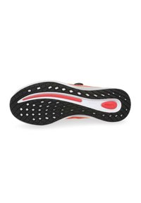Black rubber outsole with a diamond pattern, white midsole featuring red accents, and textured fabric upper in various shades of orange.
