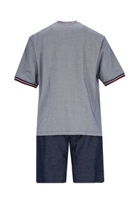 Gray short-sleeve shirt with red and navy accents on the collar and sleeves, paired with dark navy shorts, made from a textured fabric.