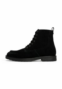 Black suede lace-up ankle boot with pull tab and low stacked heel, side view on white background.